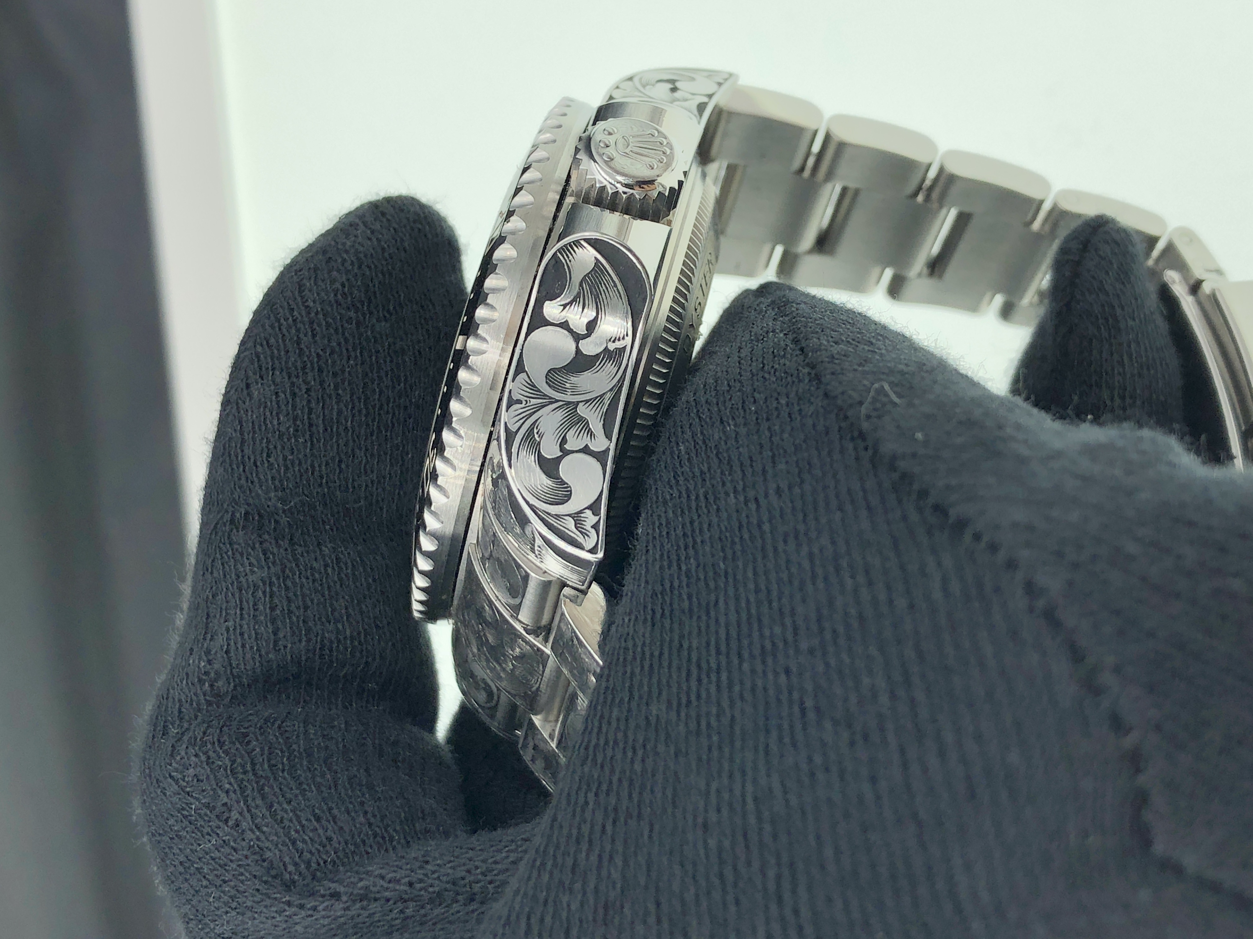 Floral engraving across case and bracelet