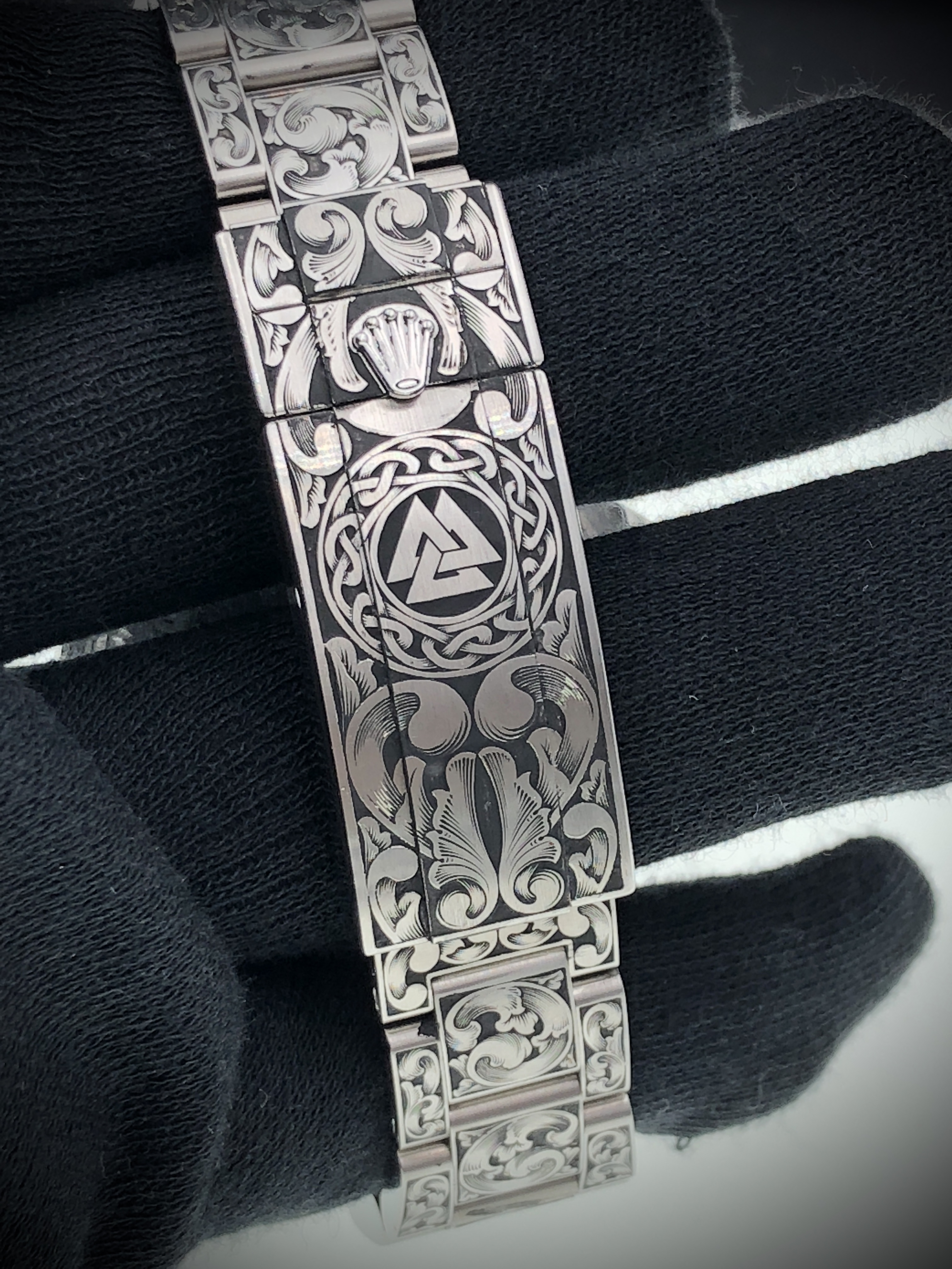 Geometric emblem and floral clasp engraving